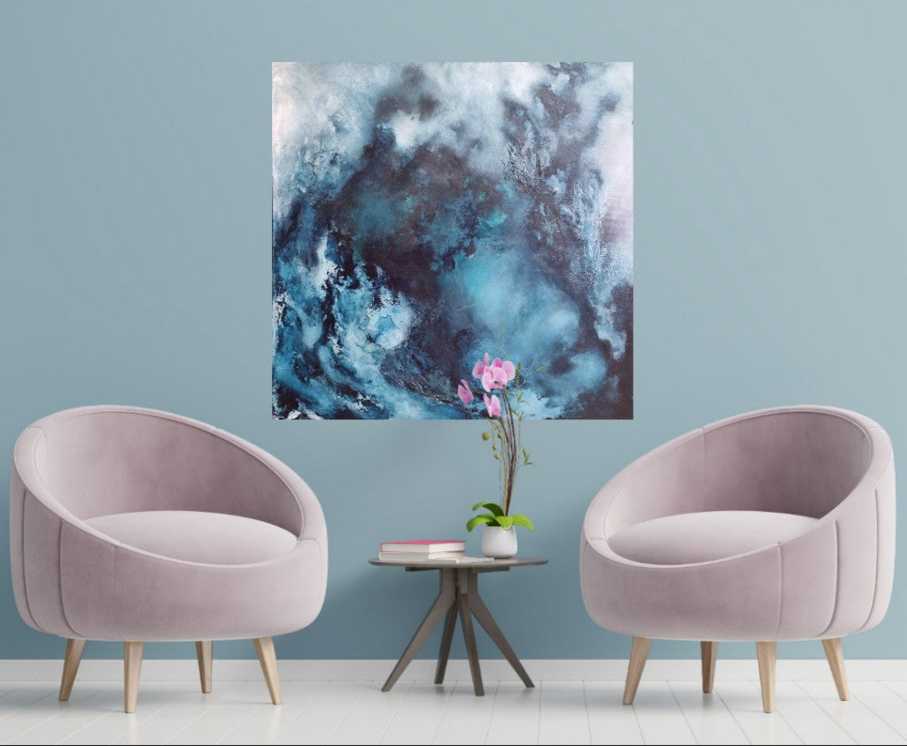 Large blue abstract painting hanging on the light blue wall above 2 light pink armchairs.